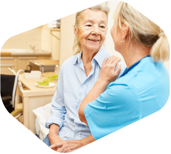 Female Medical Expert Talking with Elderly Female Patient in Clinic Setting -iTacit