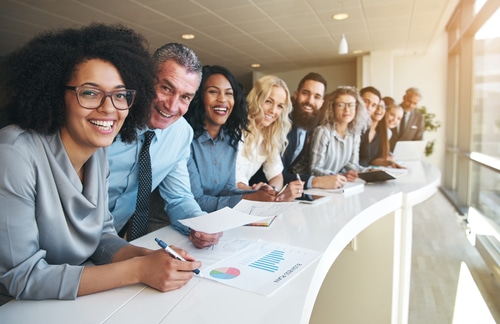 Group of happy employees looking at camera