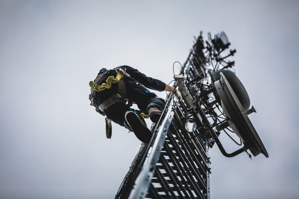 Telecom Field Worker Climbing up Pole on a Job - iTacit