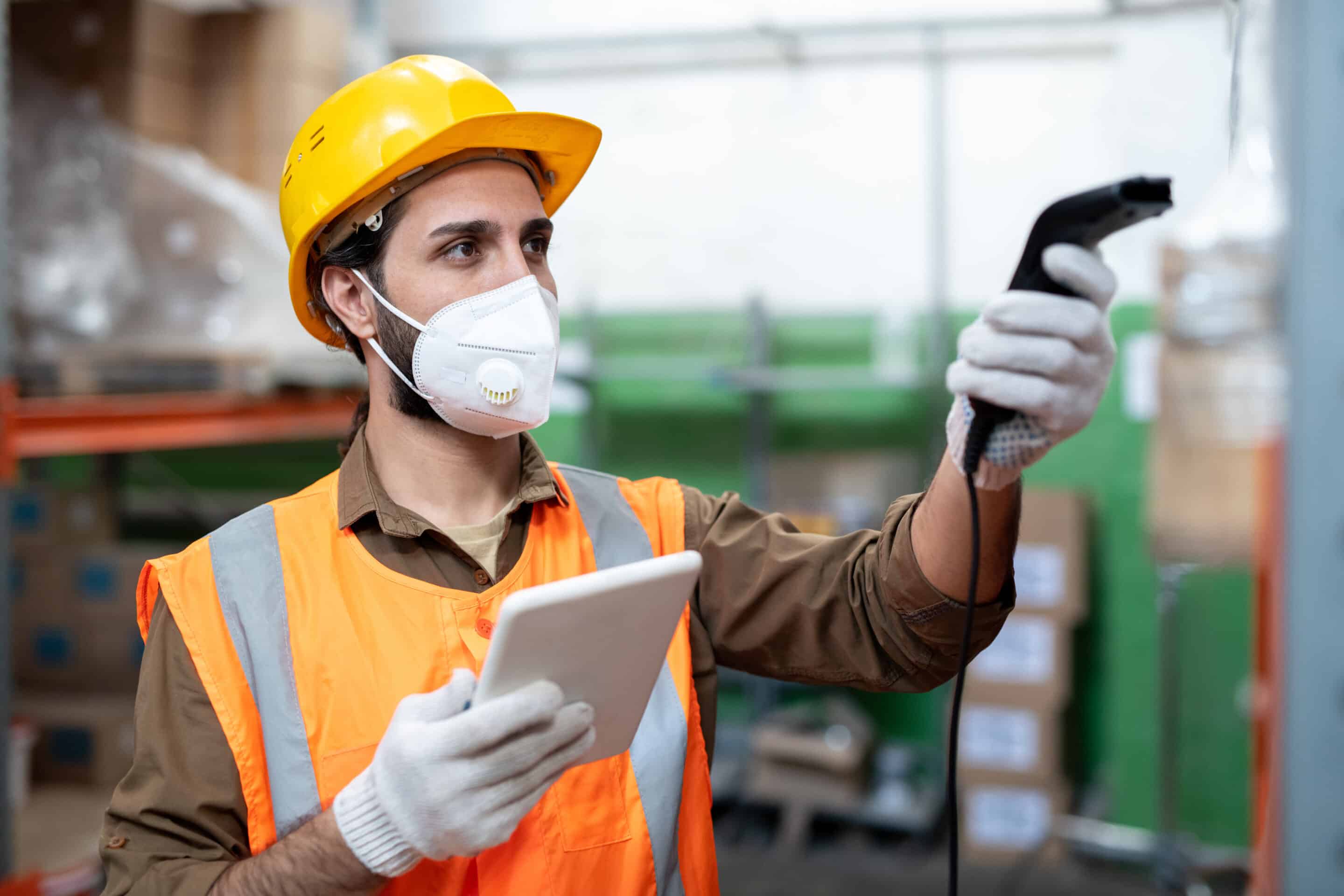 Factory Worker Utilizing Digital Work Instructions on Tablet and Holding Scanner - iTacit