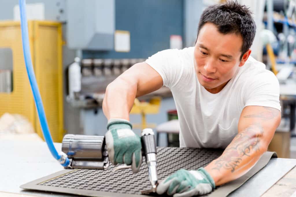 Happy engaged employee working at production plant