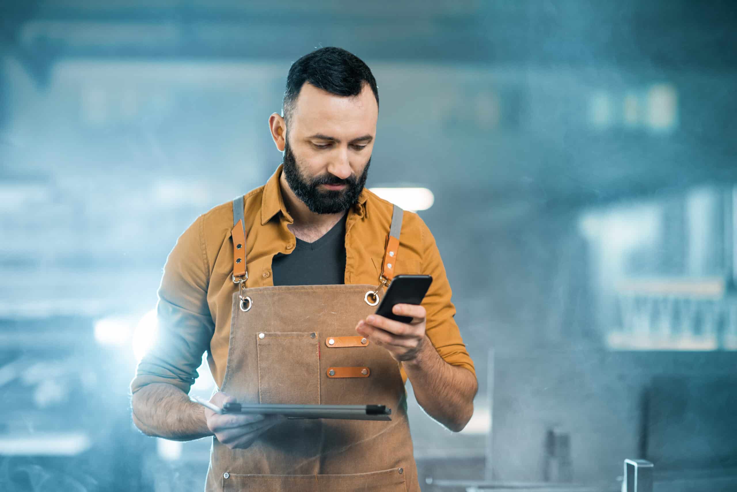 factory-worker-with-tablet-and-phone-at-the-manufa-2021-04-06-18-48-58-utc