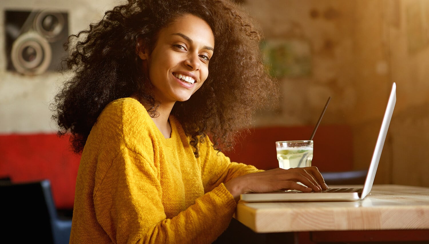 smiling-young-african-woman-sitting-in-a-cafe-PJPFWJE (2)