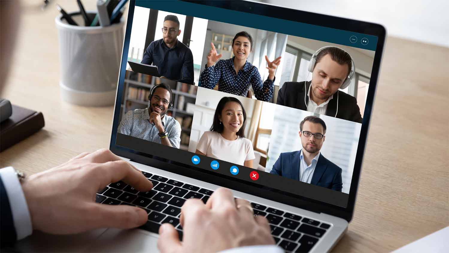 Laptop Screen Showing Manager Engaging Remote Team During Meeting - iTacit