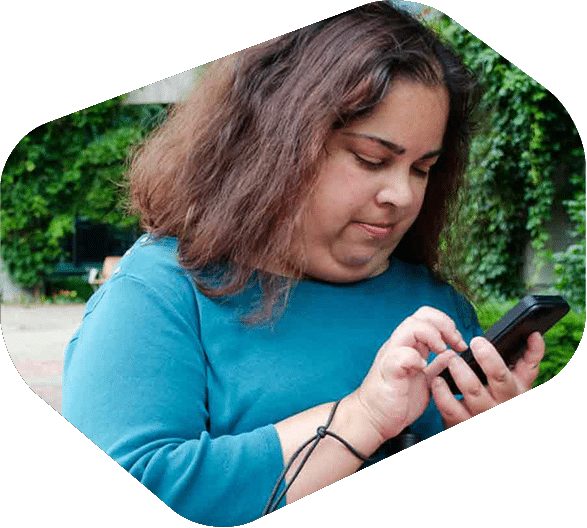 Woman Standing Outside Looking Down While Using Smartphone - iTacit