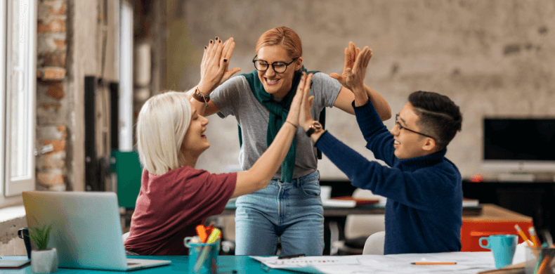 3 employees giving each other a high five