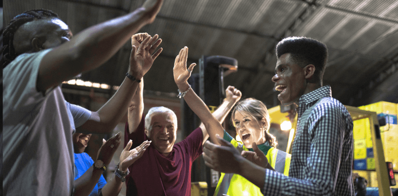 Employees in a warehouse celebrating