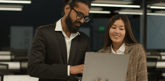 Employees looking at laptop