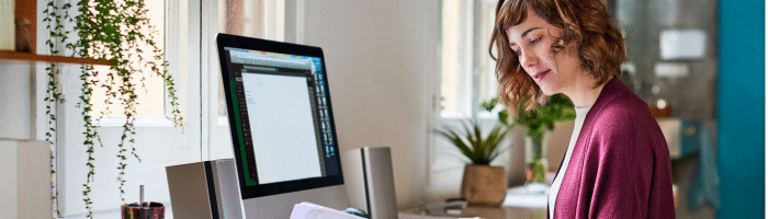 a woman siting at a desk working as a hospital admin